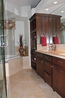 Stone tile on floor, tub and shower stall, and vanity by Rock Solid Creations, Inc.