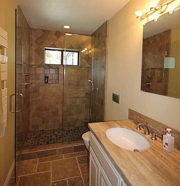 Artistic bathroom stone countertops, flooring and shower stall.