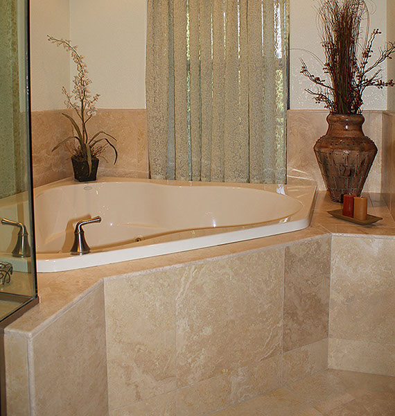 Beautiful tan marble tiling installation on bathroom jaccuzi.