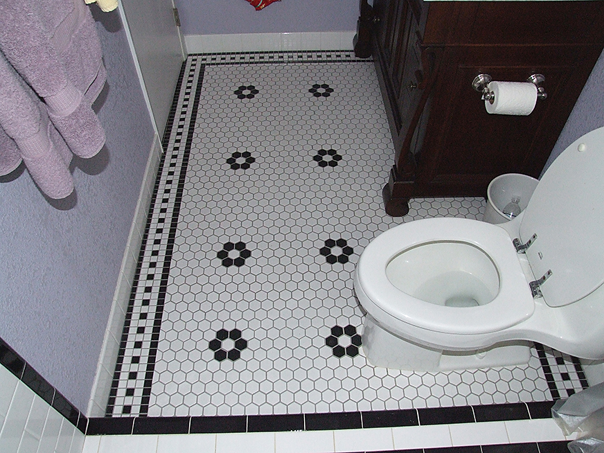 Black and white ceramic tile floor installation.