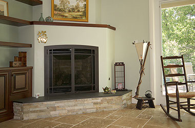 Stone tile floor and stone facing on fireplace by Rock Solid Creations, Inc.