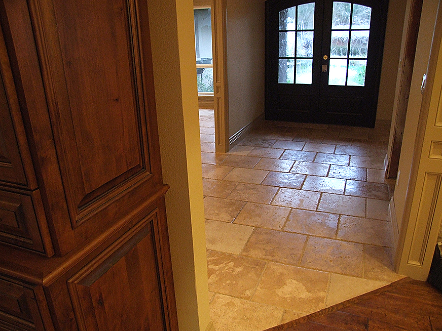 Stone floor tiling in hallway, vestibule and living room.