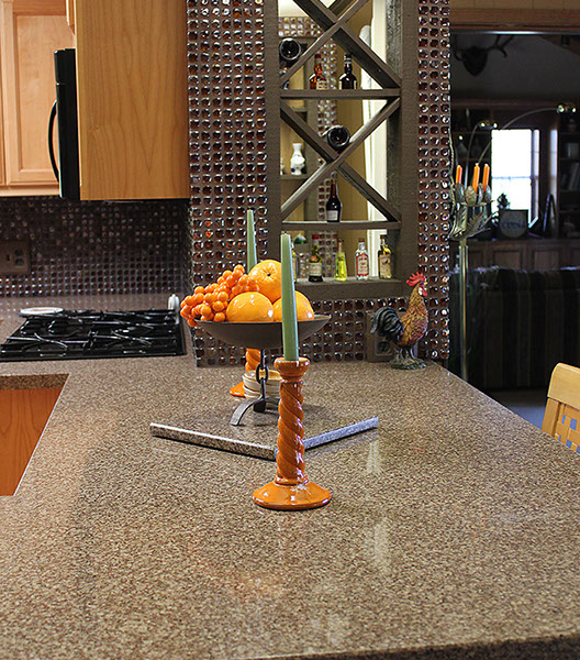 Granite countertop and glass mini tile wall installation.