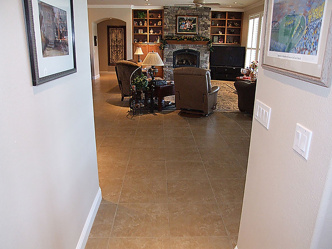 Living room stone floor tiling and rough stone fireplace tiles, design and installation.